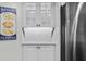 White shaker cabinets and a built-in hutch offer ample storage at 5916 Midnight Pass Rd # 103, Sarasota, FL 34242