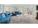 Living room with blue sofas, a coffee table, and access to a balcony at 5916 Midnight Pass Rd # 103, Sarasota, FL 34242