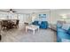 Bright living room features comfy sofas, a coffee table, and hardwood floors at 5916 Midnight Pass Rd # 103, Sarasota, FL 34242