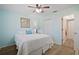 Cozy bedroom with a queen bed, light blue walls, and wood-look flooring at 6118 29Th W Ave # 6118, Bradenton, FL 34209