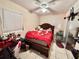 Bedroom with double bed, red coverlet, and ample closet space at 616 63Rd W Ave, Bradenton, FL 34207