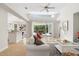 Light-filled living room featuring high ceilings, tiled floors, and an open layout leading to an outdoor patio at 6416 Wentworth Xing, University Park, FL 34201