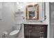 Bathroom with a modern vanity, large mirror, and a toilet in a bright space at 6805 13Th Avenue W Dr, Bradenton, FL 34209