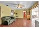 Living room with tile floors, ceiling fan, yellow walls, and views to kitchen and sun room at 6805 13Th Avenue W Dr, Bradenton, FL 34209