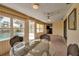 Dining area in an enclosed sunroom featuring great natural light and views of the pool at 6805 13Th Avenue W Dr, Bradenton, FL 34209