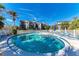 Community pool with lounge chairs and patio umbrellas at 6840 Midnight Pass Rd # 6840, Sarasota, FL 34242