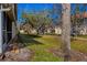 Landscaped backyard with mature trees and pathway at 7133 Cedar Hollow Cir # 22-102, Bradenton, FL 34203