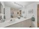 Clean bathroom with dual sinks, large mirror, and good storage at 7133 Cedar Hollow Cir # 22-102, Bradenton, FL 34203