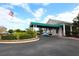 Attractive community entrance with covered drop-off and lush landscaping at 7133 Cedar Hollow Cir # 22-102, Bradenton, FL 34203