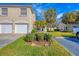 Tan two-story condo with two-car garage and manicured lawn at 7133 Cedar Hollow Cir # 22-102, Bradenton, FL 34203