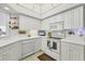 Bright eat-in kitchen features white cabinetry, updated appliances, and ample counter space at 7133 Cedar Hollow Cir # 22-102, Bradenton, FL 34203