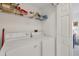 Convenient laundry room with washer, dryer, and shelving for storage at 7133 Cedar Hollow Cir # 22-102, Bradenton, FL 34203