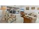 Bright living room with comfy seating, large TV, and sliding glass doors at 7133 Cedar Hollow Cir # 22-102, Bradenton, FL 34203