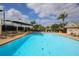 Relaxing community pool area with surrounding lounge chairs at 7133 Cedar Hollow Cir # 22-102, Bradenton, FL 34203