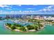 Stunning aerial view of a marina with yachts docked on the water, surrounded by lush landscape and buildings at 7911 Moonstone Dr # 26-203, Sarasota, FL 34233