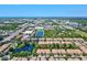 An aerial shot displays a beautiful neighborhood near lakes and the ocean under a clear, blue sky at 7911 Moonstone Dr # 26-203, Sarasota, FL 34233