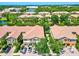 Stunning aerial view of townhomes surrounded by lush landscaping, a serene lake, and a beautiful community at 7911 Moonstone Dr # 26-203, Sarasota, FL 34233