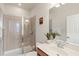 Bathroom with a glass-enclosed shower, tile, and vanity with a chrome faucet at 7911 Moonstone Dr # 26-203, Sarasota, FL 34233
