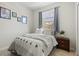Comfortable bedroom with a window view, stylish decor, and a soothing ambiance at 7911 Moonstone Dr # 26-203, Sarasota, FL 34233