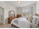 Cozy bedroom with wooden furniture, natural light, and a serene atmosphere at 7911 Moonstone Dr # 26-203, Sarasota, FL 34233