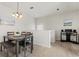 Cozy dining area with modern decor, stylish lighting, and hardwood floors at 7911 Moonstone Dr # 26-203, Sarasota, FL 34233