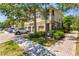 Beautiful townhome exterior with a two-car garage, lush landscaping, and a well-maintained brick driveway at 7911 Moonstone Dr # 26-203, Sarasota, FL 34233