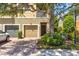 Inviting two-story townhome with a two-car garage and a well-maintained front yard at 7911 Moonstone Dr # 26-203, Sarasota, FL 34233