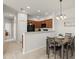 Open kitchen featuring wooden cabinets, a breakfast bar, and sleek black appliances at 7911 Moonstone Dr # 26-203, Sarasota, FL 34233