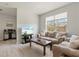 Inviting living room featuring a comfortable sofa, large window, and modern entertainment setup at 7911 Moonstone Dr # 26-203, Sarasota, FL 34233