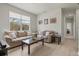Bright living room with a large window, neutral decor, and hardwood floors at 7911 Moonstone Dr # 26-203, Sarasota, FL 34233