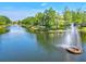 Picturesque lake with a fountain, surrounded by lush greenery and trees within the community at 7911 Moonstone Dr # 26-203, Sarasota, FL 34233