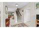 Bright and spacious entryway with staircase and views to living area at 800 Hudson Ave # 105, Sarasota, FL 34236