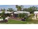 Attractive single-wide home with landscaped yard and carport at 8520 Imperial Cir, Palmetto, FL 34221