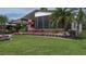 Landscaped yard with flowering plants and a single-story home at 8520 Imperial Cir, Palmetto, FL 34221