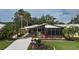Single-story home with landscaped yard, covered porch and carport at 8520 Imperial Cir, Palmetto, FL 34221