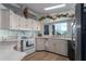 Bright kitchen featuring white cabinets and stainless steel appliances at 8520 Imperial Cir, Palmetto, FL 34221