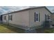 Rear view of the home highlighting the exterior condition and landscaping at 8520 Imperial Cir, Palmetto, FL 34221