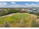 Picturesque aerial view of the community with golf course, beautiful ponds, and lush landscapes at 9214 Raes Creek Pl, Palmetto, FL 34221