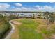 Aerial view of the community, golf course, ponds, and surrounding lush greenery at 9214 Raes Creek Pl, Palmetto, FL 34221