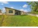 View of backyard, home's lanai, well-kept lawn and white picket fence at 9214 Raes Creek Pl, Palmetto, FL 34221