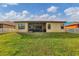 Home's backyard with large lawn, lanai, and view of picket fencing at 9214 Raes Creek Pl, Palmetto, FL 34221