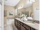 Bathroom featuring granite counters, double sinks, a soaking tub, and a glass shower at 9214 Raes Creek Pl, Palmetto, FL 34221