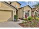 Lovely single-story home with manicured flower beds, a three-car garage, and a well-kept lawn at 9214 Raes Creek Pl, Palmetto, FL 34221