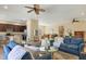 A living room showcasing an open floor plan connected to the kitchen and dining area at 9214 Raes Creek Pl, Palmetto, FL 34221