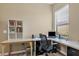 Bright office area featuring a workstation, a rolling office chair, and natural lighting at 9214 Raes Creek Pl, Palmetto, FL 34221