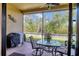 Relaxing screened patio with ceiling fan, brick flooring, and peaceful views, great for outdoor dining and grilling at 9214 Raes Creek Pl, Palmetto, FL 34221