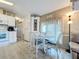 Bright kitchen with white cabinets and a dining area at 3333 26Th E Ave # 1120, Bradenton, FL 34208
