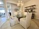 Elegant dining area with a glass table and modern chandelier at 7709 River Preserve Dr, Bradenton, FL 34212