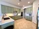 Modern kitchen with light green cabinets, quartz countertops, and stainless steel appliances at 7709 River Preserve Dr, Bradenton, FL 34212