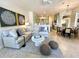 Open living room boasts sectional sofa and adjacent dining area at 7709 River Preserve Dr, Bradenton, FL 34212